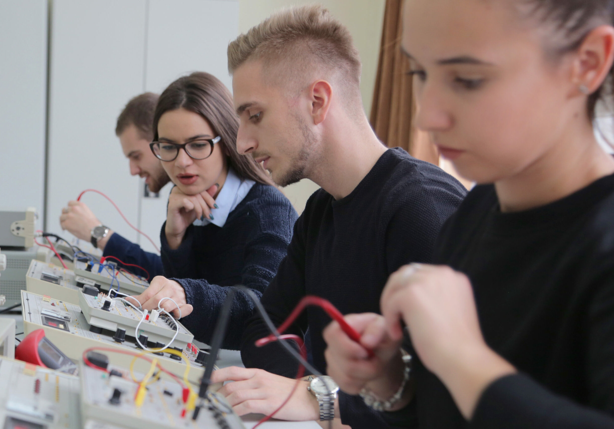 Group of young students in technical vocational training with teacher, the lesson in technical college. Education and technology concept.